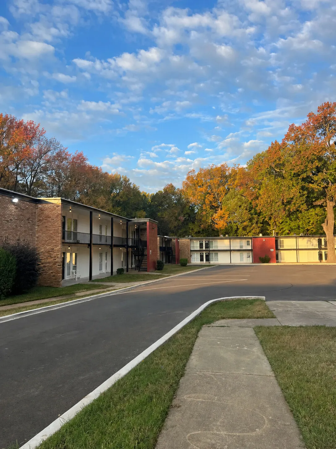 North Pointe Apartments — two-story buildings along a quiet drive on an autumn morning